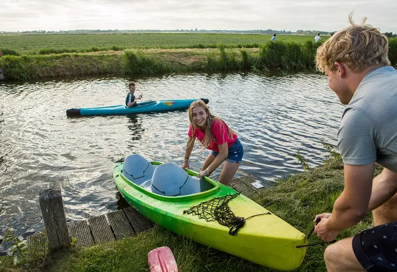 Er wordt een kano uit het water getrokken