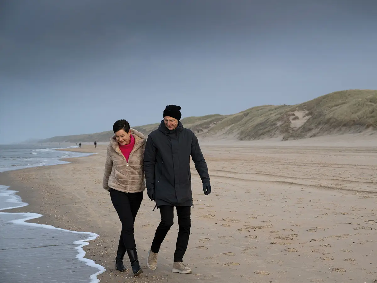 Stel wandelt over het strand in de winter